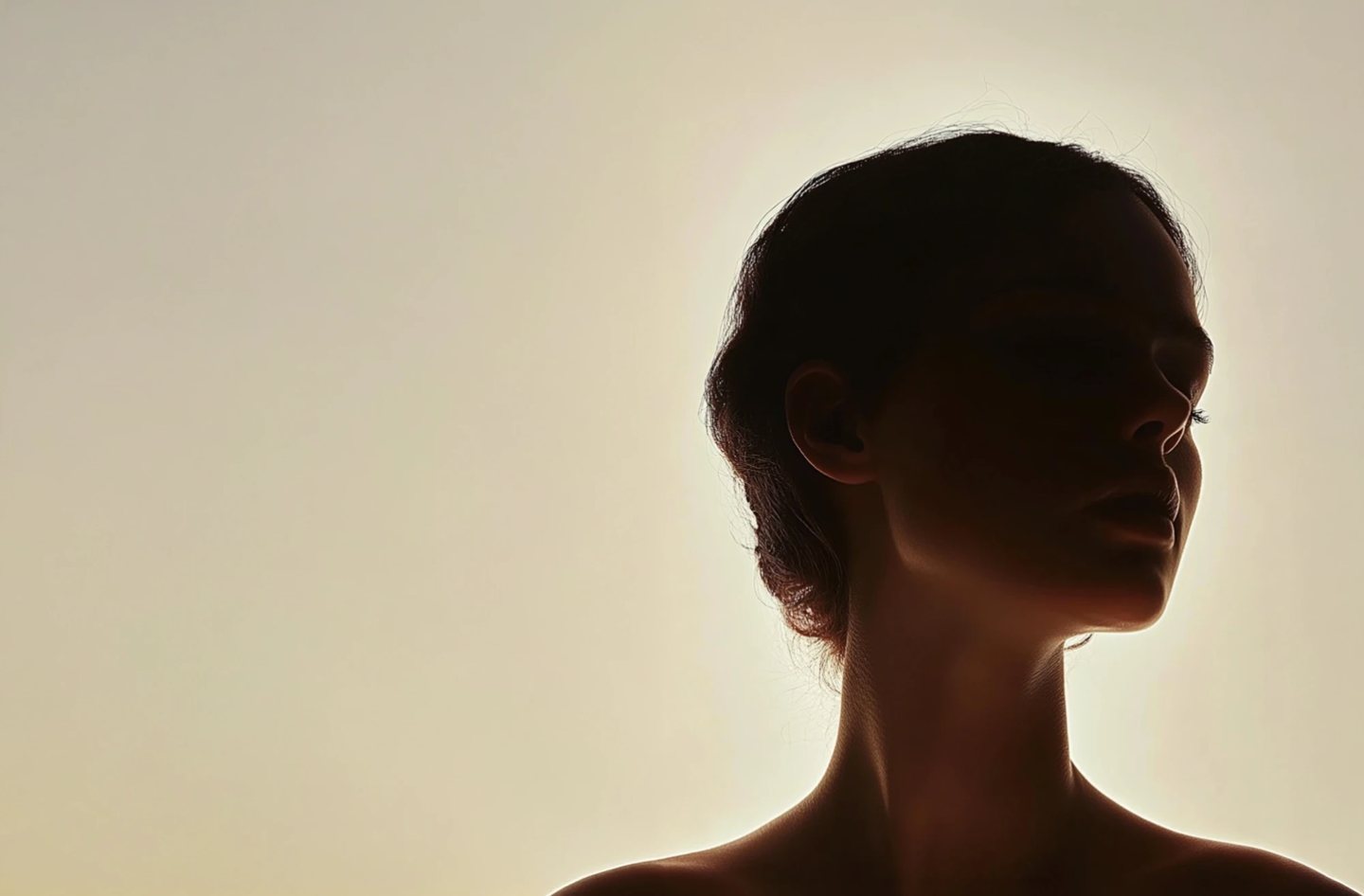 A backlit profile against soft warm light