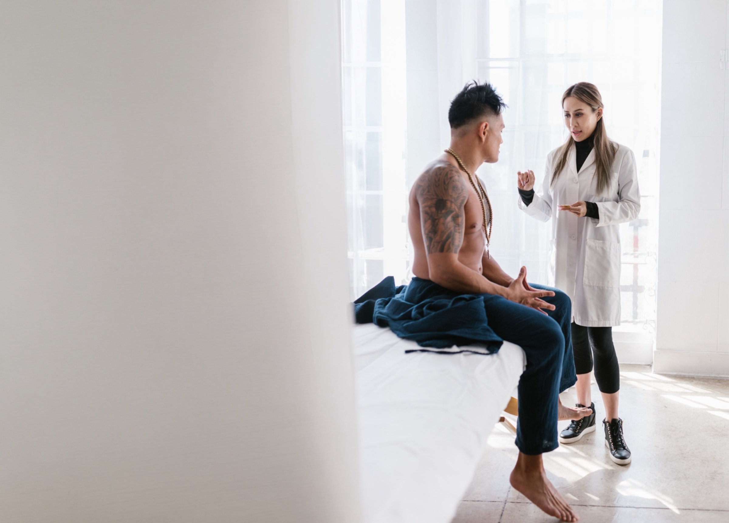 An unhurried physician greeting a patient in a refined practice setting
